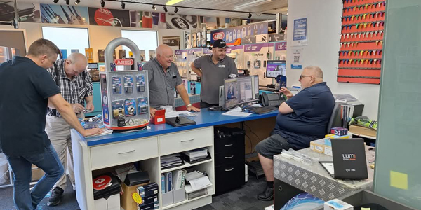 People standing around the LSC store counter talking